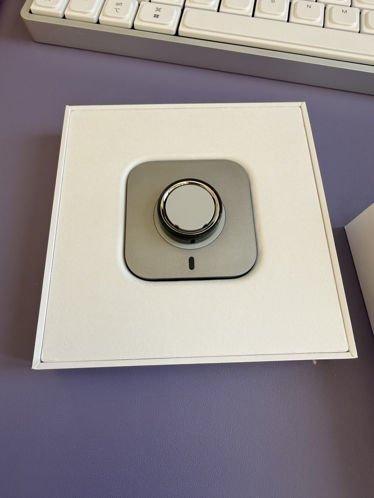 My Oura Ring 4 on its charger in the open box