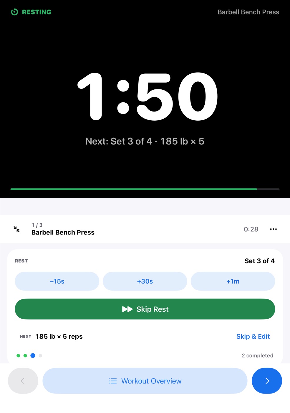 Seated mode while resting: a large 1:58 countdown and the next set on the dark upright half; rest adjustments and Skip Rest on the flat bottom half.